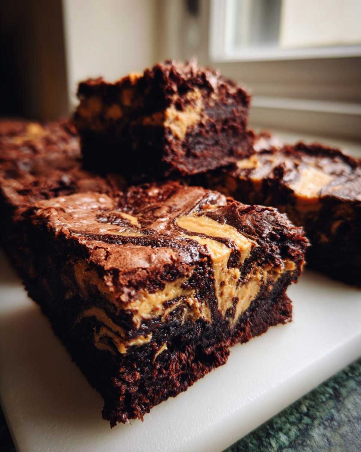 Close-up of fudgy peanut butter swirl brownies, showing the rich chocolate base and creamy peanut butter ribbons.